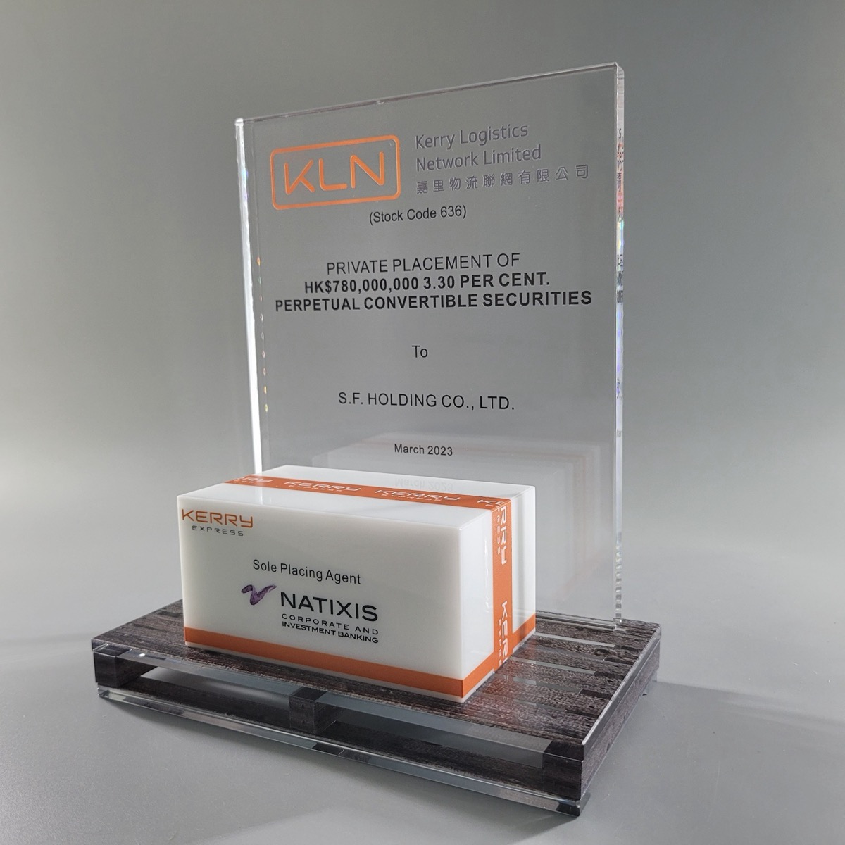 Lucite deal toy with an embedded branded carton on a crystal pallet base, made by Crystal Century in Hong Kong